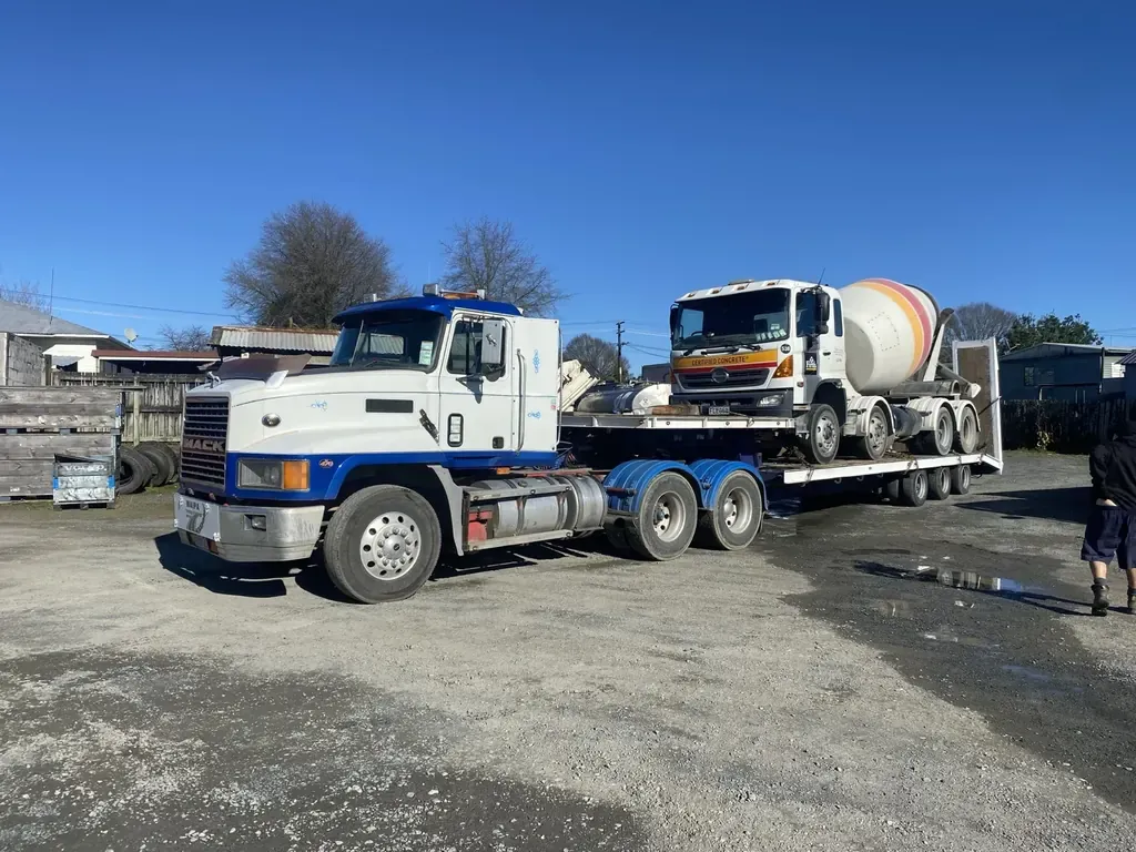 Concrete mixer truck recovered onto a heavy transporter