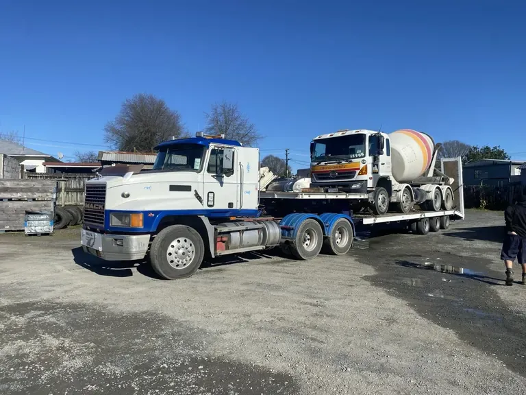 Concrete mixer truck recovered onto a heavy transporter