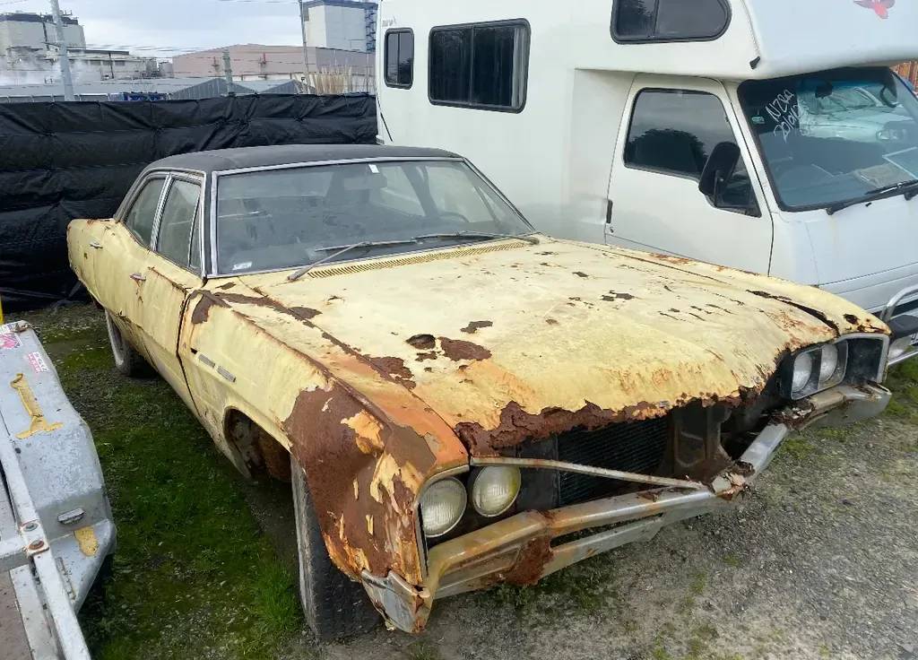 Scrap car being loaded for removal